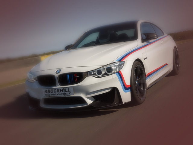 BMW M4 car accelerating on the Knockhill track