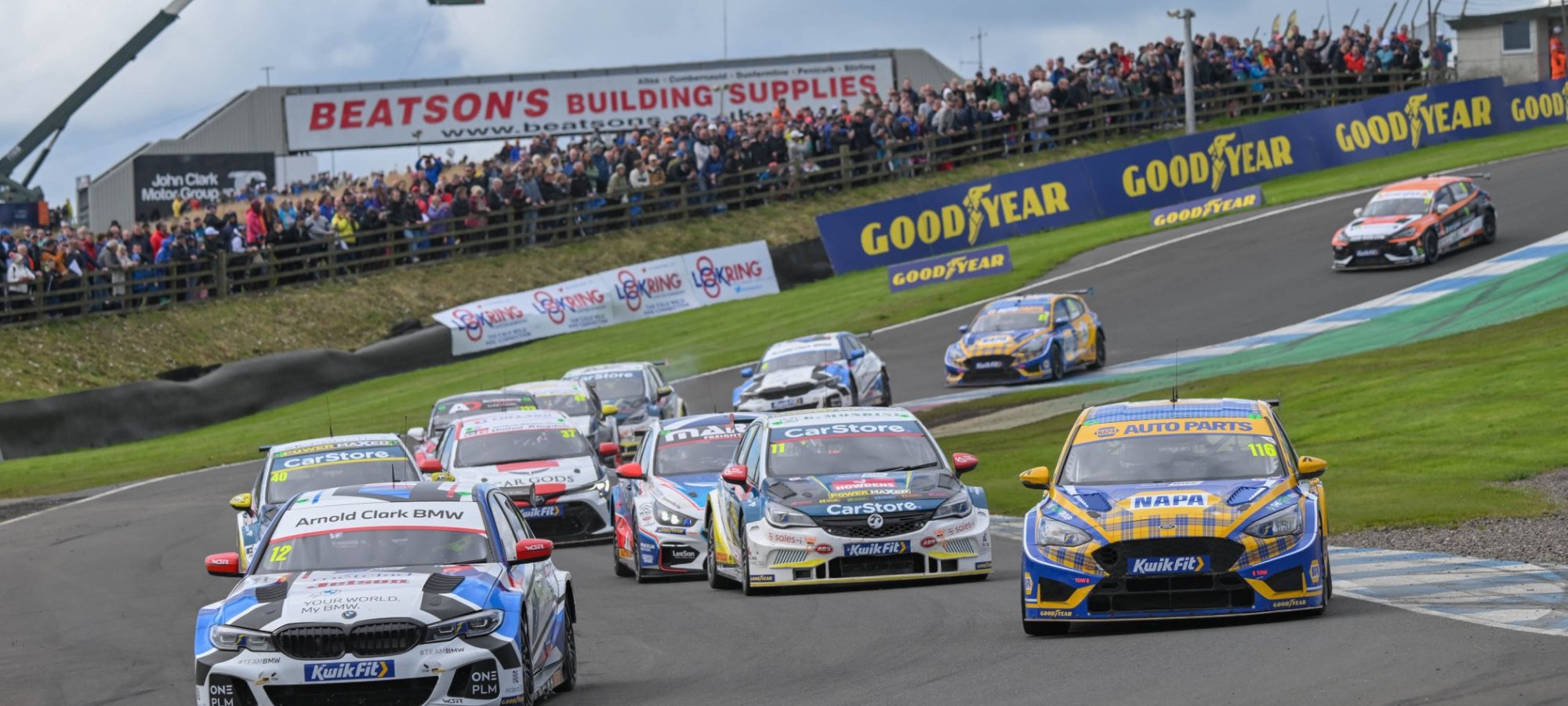 BTCC cars fighting through the Knockhill hairpin